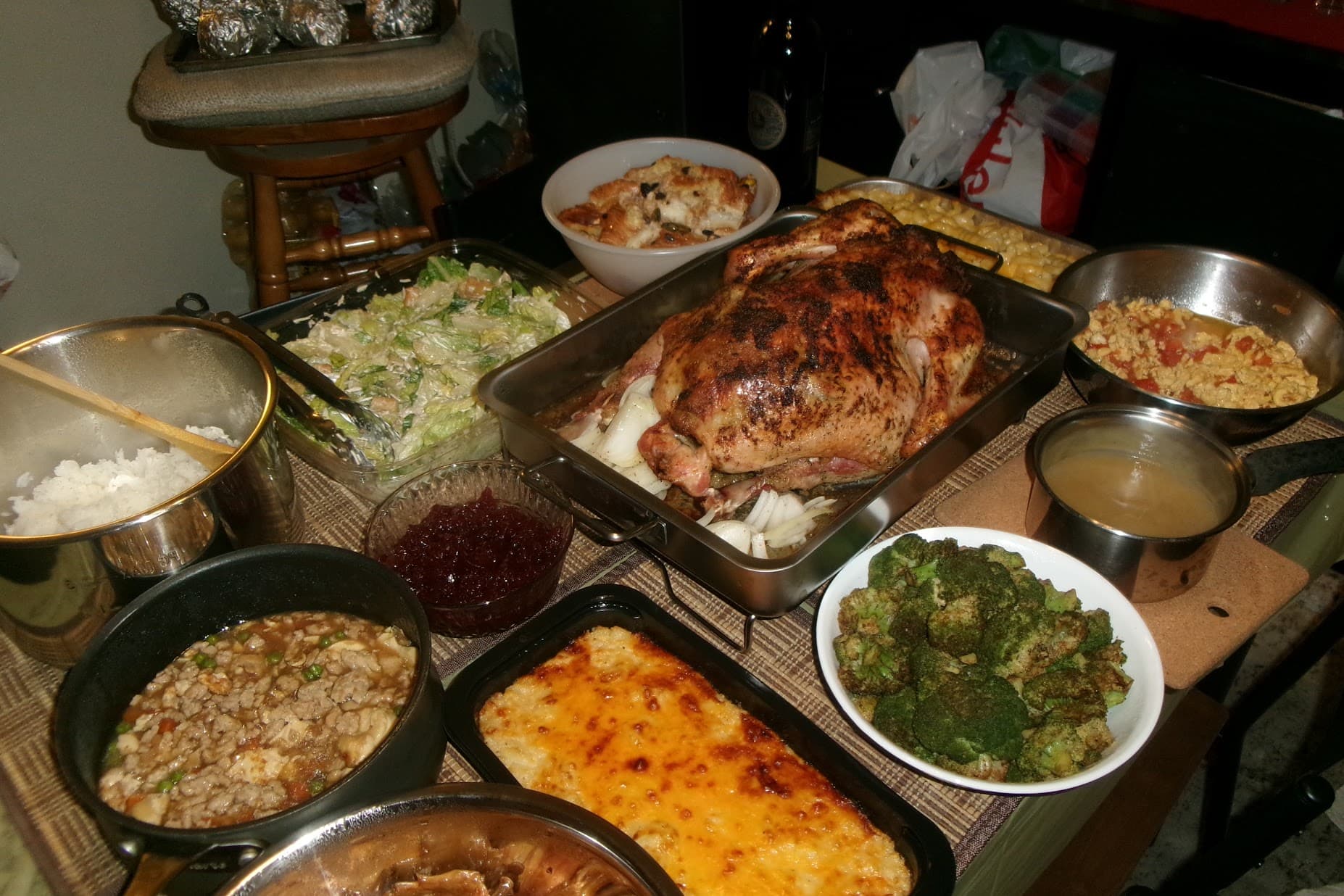 A homemade Thanksgiving spread gathered around a roast turkey