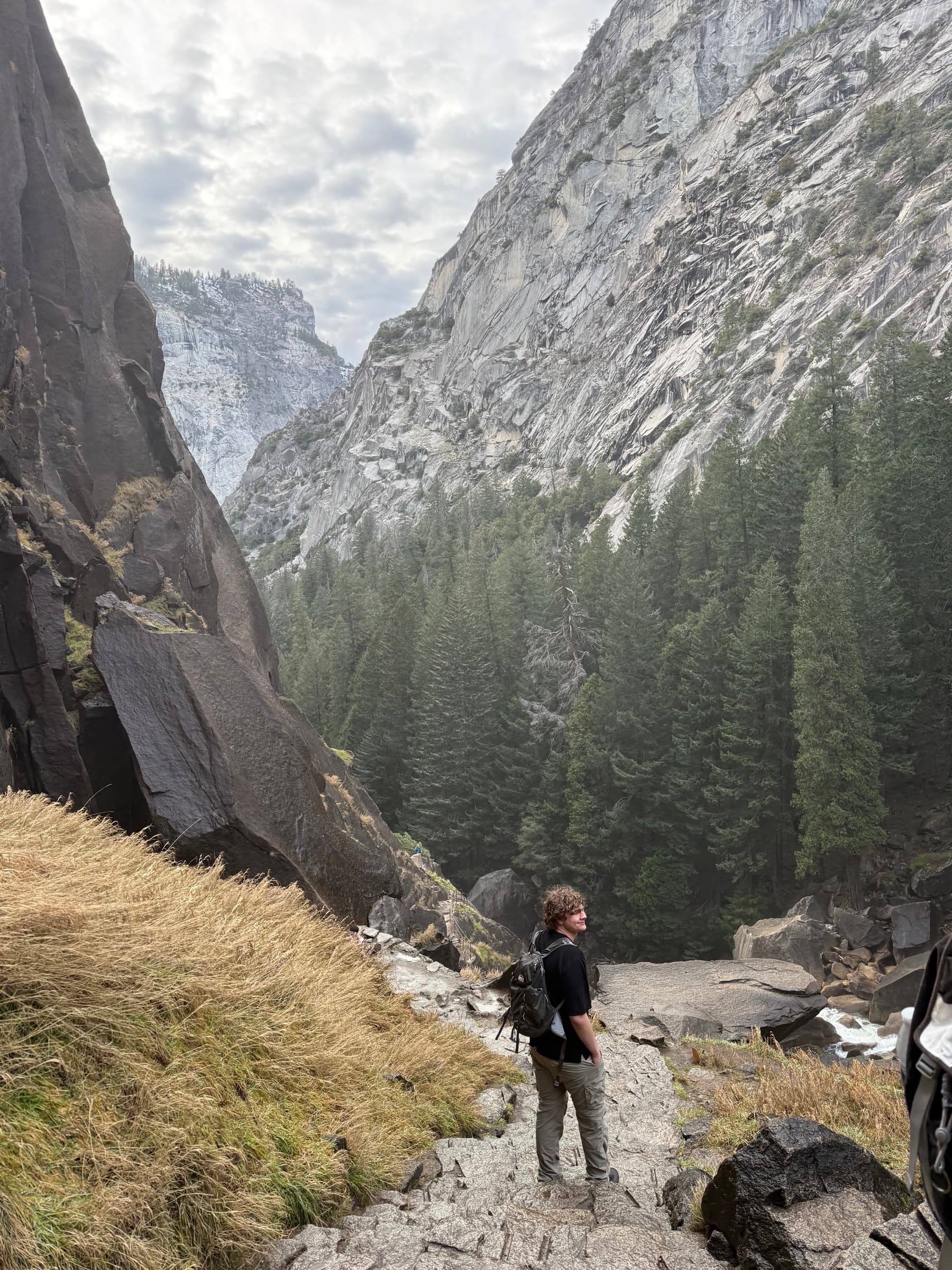 Aidan standing on a trail overlooking Yosemite Valley